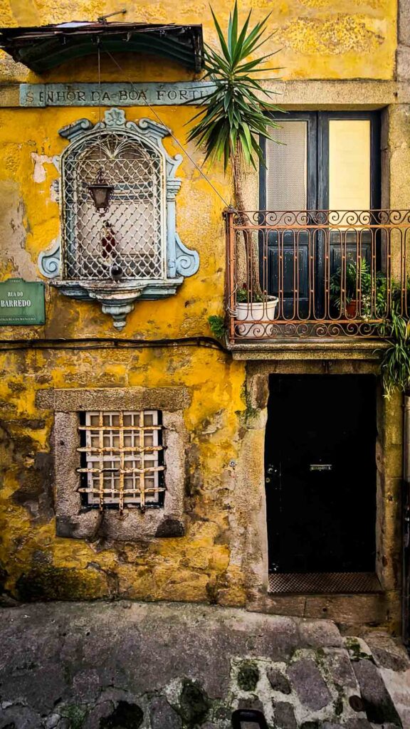 photo of yellow residential facade in the alleys of Porto, Portugal