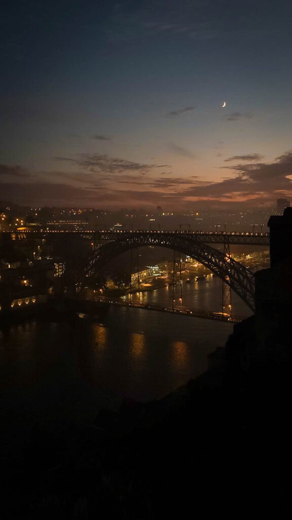 What to do in Porto Portugal view of moon over Luis 1 bridge