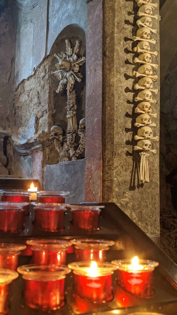 The red candle-lit mantle at the Bone Church in Kutna Hora
