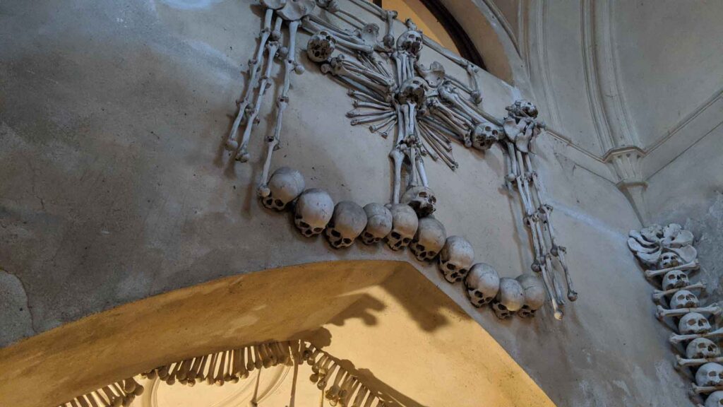 Entry stairwell wall covering of skulls and bones at the Bone Church in Kutna Hora