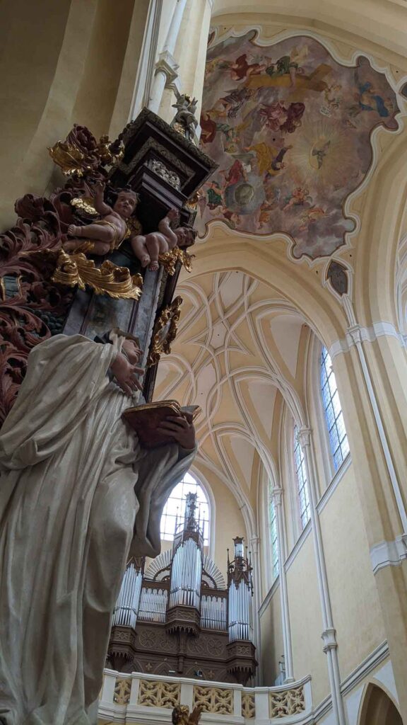 The ceiling fresco, statue and organ at the Cathedral of Assumption of Our Lady and St. John the Baptist in Kutna Hora