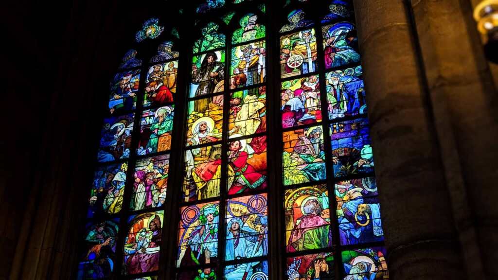 A detailed photo of the Alphonse Mucha stained glass window in St. Vitus Cathedral in Prague