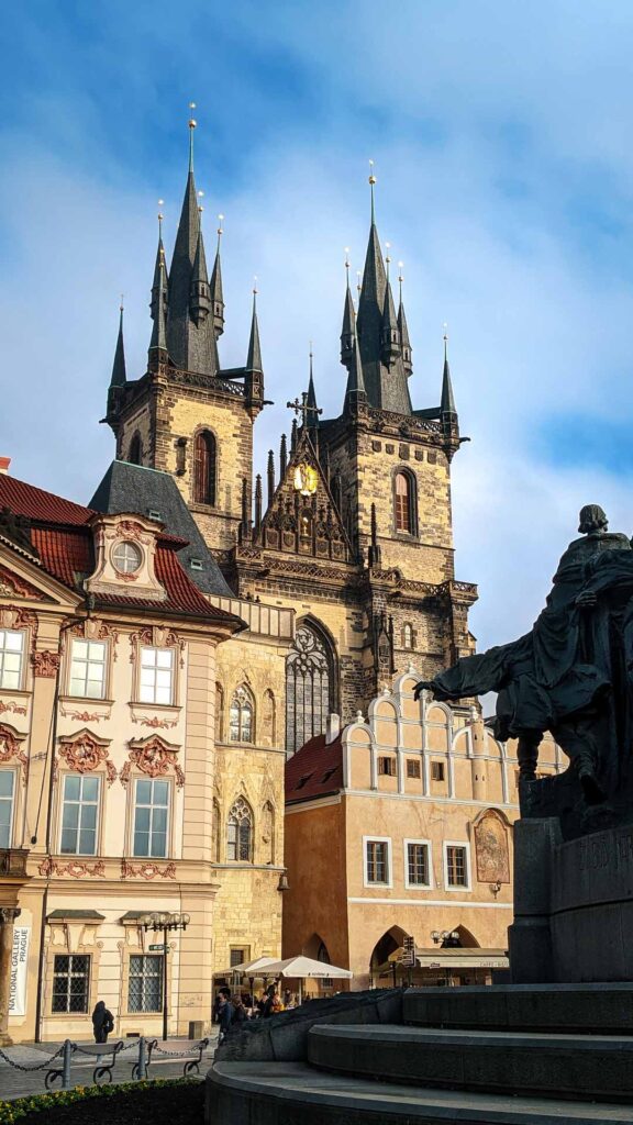 Photo of Church Of Our Lady Before Týn in Old Town Square with Jan Hus Monument in foreground